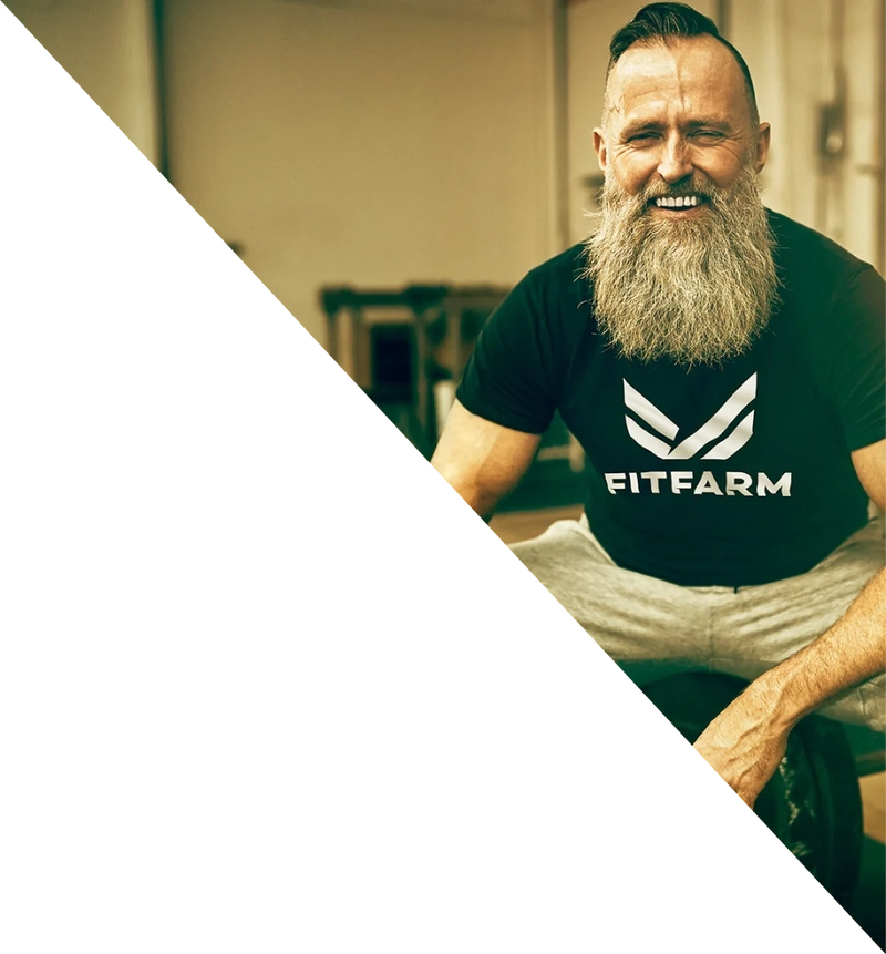 A happy older man in a Fitfarm shirt smiling back at the camera